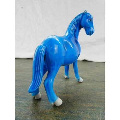 102 - A Highland Arts glazed pottery figure of a horse.