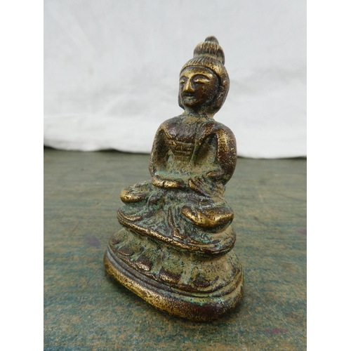 106 - A small brass ornament of a Buddha.