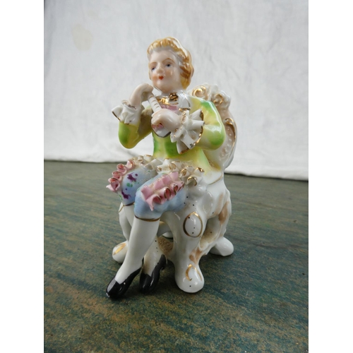 110 - A small Capodimonte figure of a violinist and a collection of other ornaments.