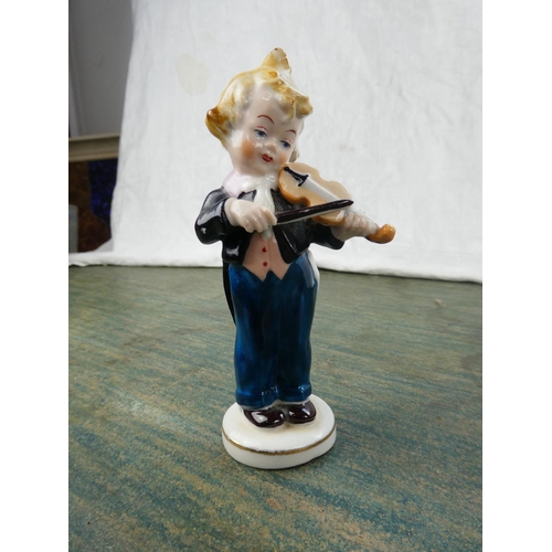 110 - A small Capodimonte figure of a violinist and a collection of other ornaments.