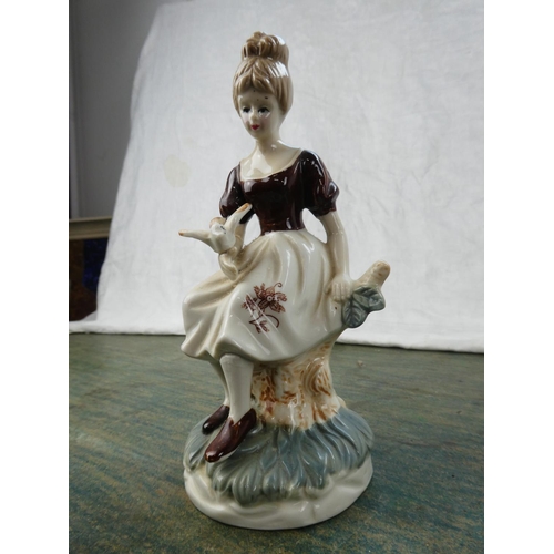 110 - A small Capodimonte figure of a violinist and a collection of other ornaments.