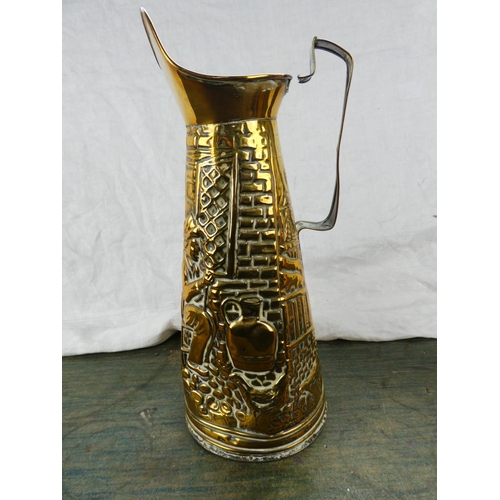 118 - A large brass embossed water jug of a tavern scene and another.