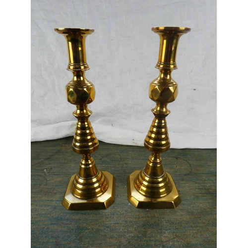 123 - A large pair of antique brass candlesticks stamped RD223580.