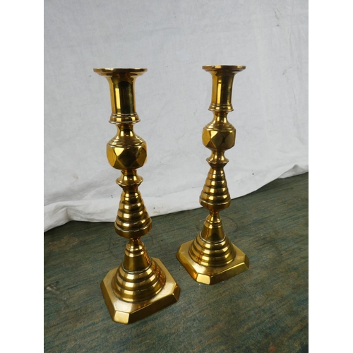 123 - A large pair of antique brass candlesticks stamped RD223580.