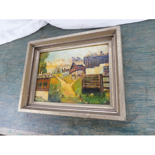 125 - A framed oil painting of a continental scene.