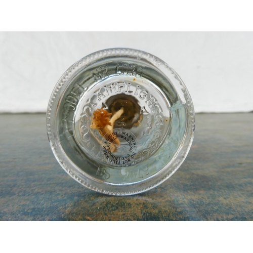 128 - A small clear glass oil lamp with a picture of a soldier on horseback.