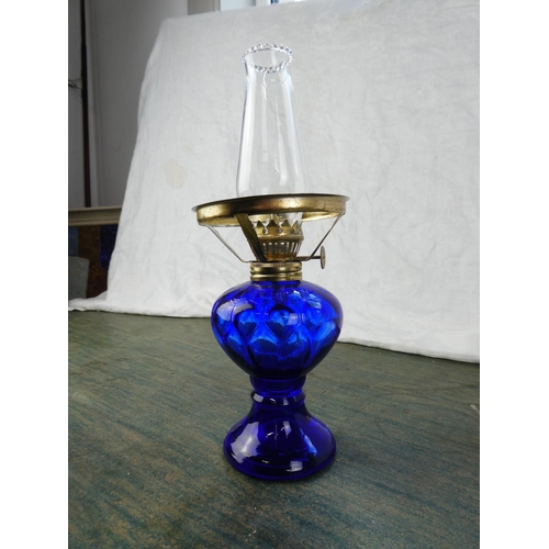 129 - A small blue glass oil lamp.