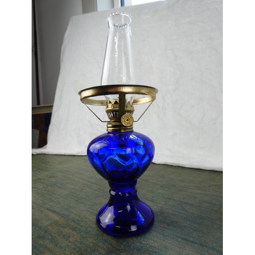 129 - A small blue glass oil lamp.