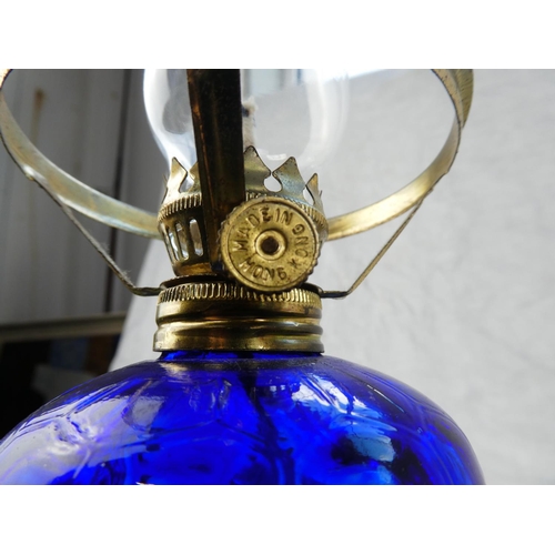 129 - A small blue glass oil lamp.