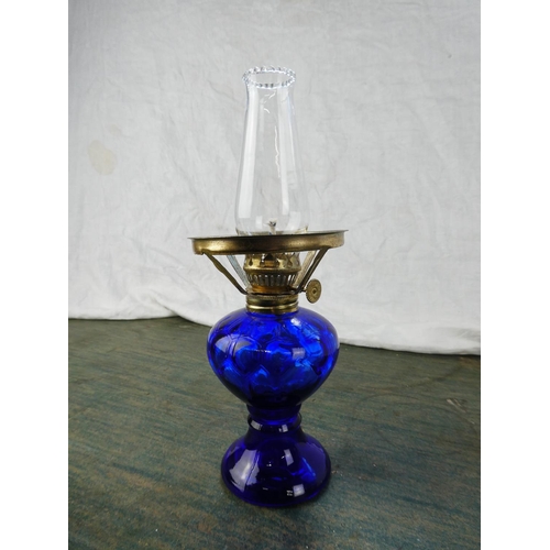 129 - A small blue glass oil lamp.