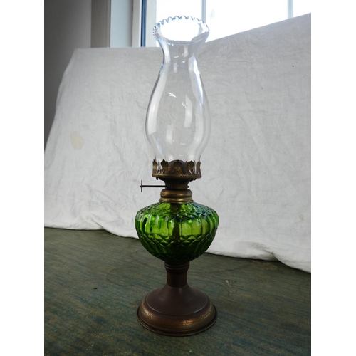 130 - A small green glass oil lamp.