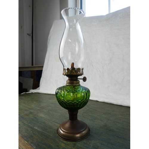 130 - A small green glass oil lamp.