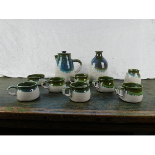 131 - A studio pottery coffee set and flagon (milk jug a/f).