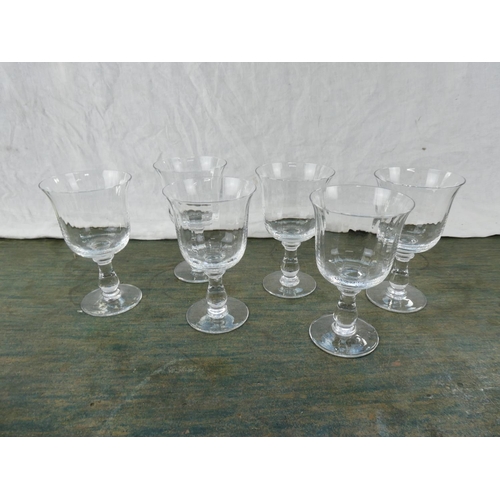 160 - A set of six tulip shaped wine glasses.