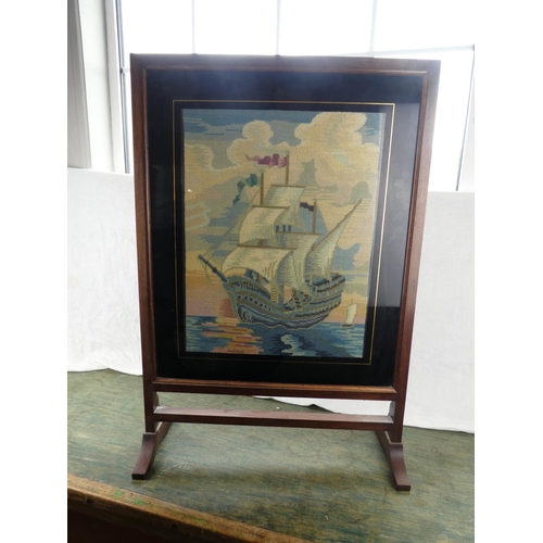 195 - A vintage oak framed tapestry firescreen of a sailing ship.