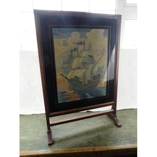 195 - A vintage oak framed tapestry firescreen of a sailing ship.