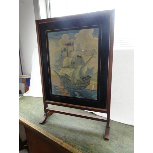 195 - A vintage oak framed tapestry firescreen of a sailing ship.