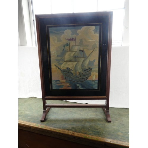 195 - A vintage oak framed tapestry firescreen of a sailing ship.