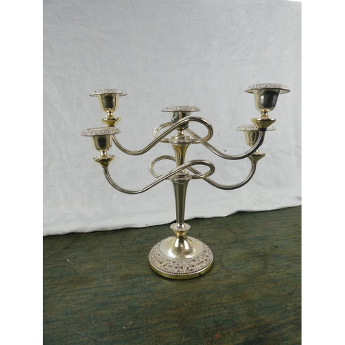 43 - A five branch silver plated candelabra.