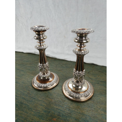 62 - A pair of gilt metal candlesticks.