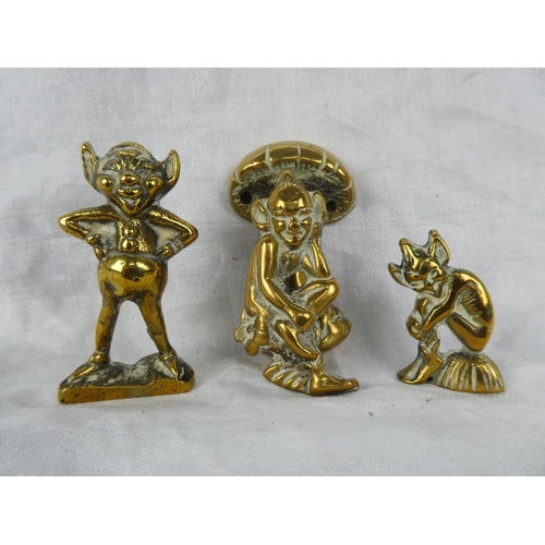 64 - A small brass cherub door knocker and two brass ornaments.