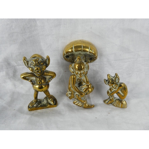 64 - A small brass cherub door knocker and two brass ornaments.