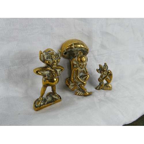 64 - A small brass cherub door knocker and two brass ornaments.