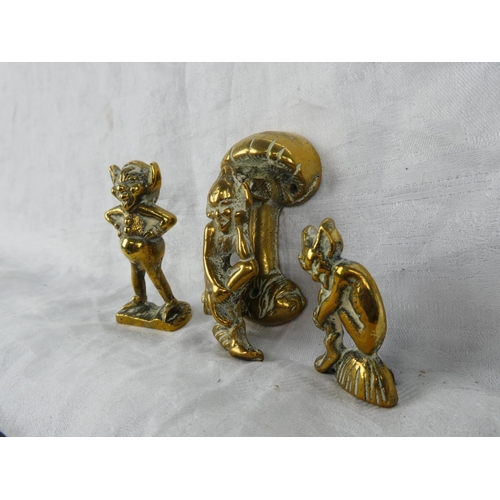 64 - A small brass cherub door knocker and two brass ornaments.