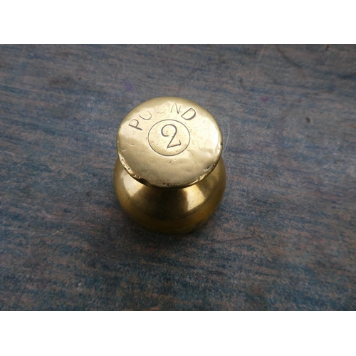 70 - A brass two pound shop weight.