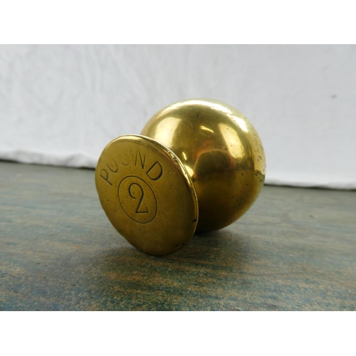 70 - A brass two pound shop weight.