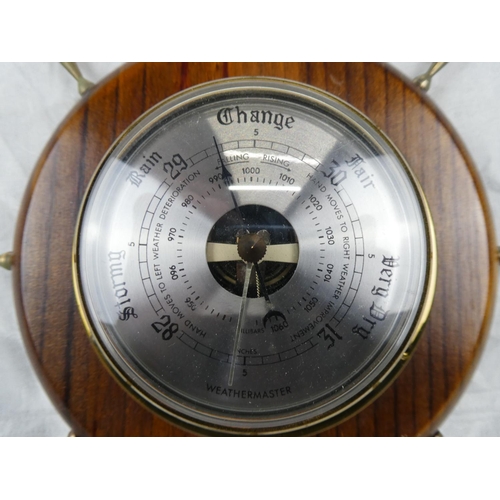 85 - A Weathermaster barometer mounted on a ship style wheel.