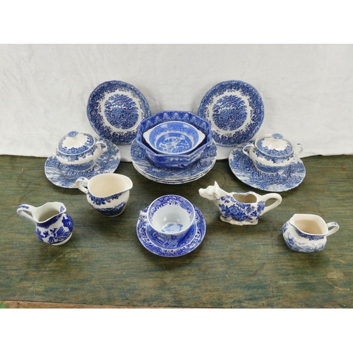 88 - A collection of blue and white ware to include a Crown Devon milk jug in the shape of a cow, a Spode... 