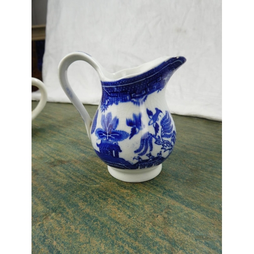 88 - A collection of blue and white ware to include a Crown Devon milk jug in the shape of a cow, a Spode... 