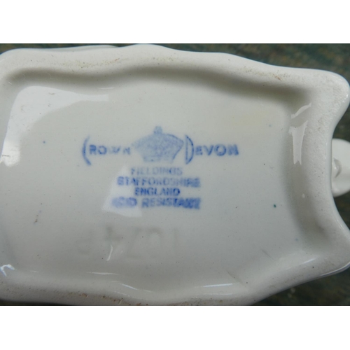 88 - A collection of blue and white ware to include a Crown Devon milk jug in the shape of a cow, a Spode... 