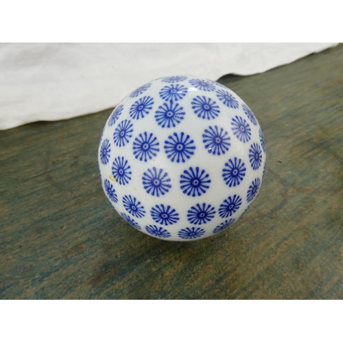 95 - A blue and white ceramic ball.