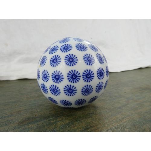 95 - A blue and white ceramic ball.