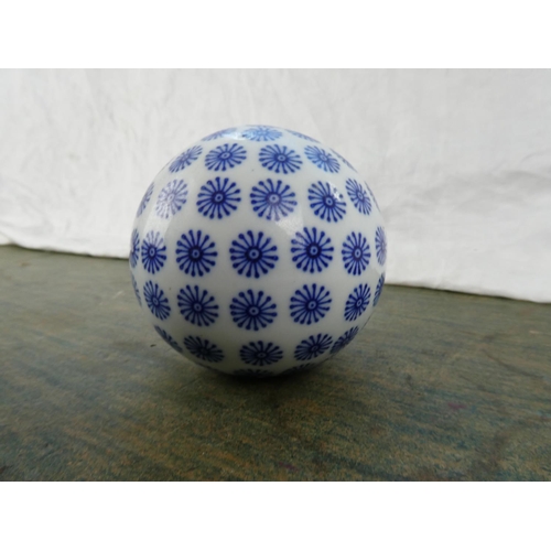 95 - A blue and white ceramic ball.