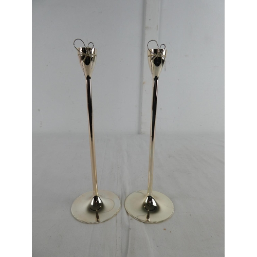 277 - A pair of Wedgwood Vera Wang candlesticks.