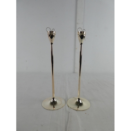 277 - A pair of Wedgwood Vera Wang candlesticks.