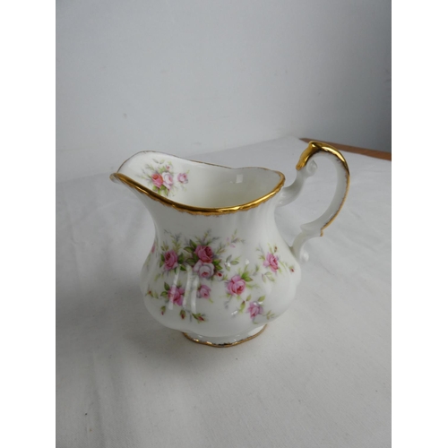 301 - A large lot of Paragon 'Victoriana Rose' table ware to include teapot, milk jug and sugar bowl, dinn... 