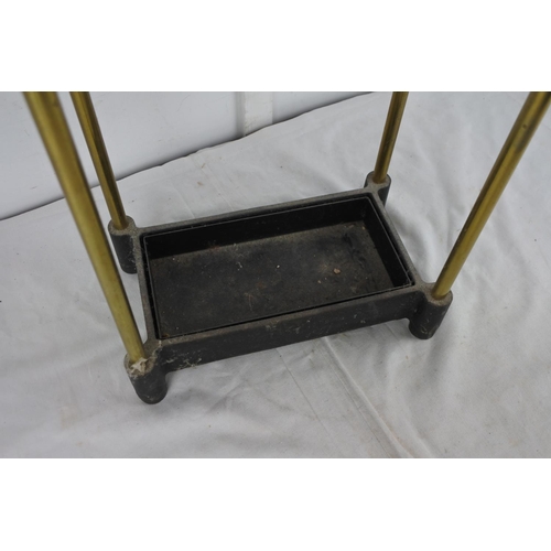 167 - A cast iron tray and brass laquared stick/umberlla stand.