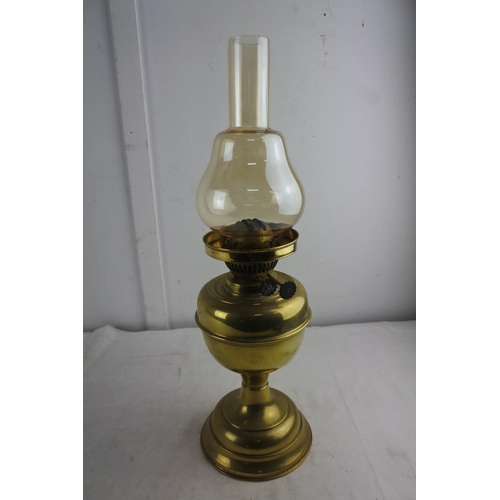 65 - A brass based oil lamp and shade.