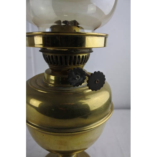 65 - A brass based oil lamp and shade.