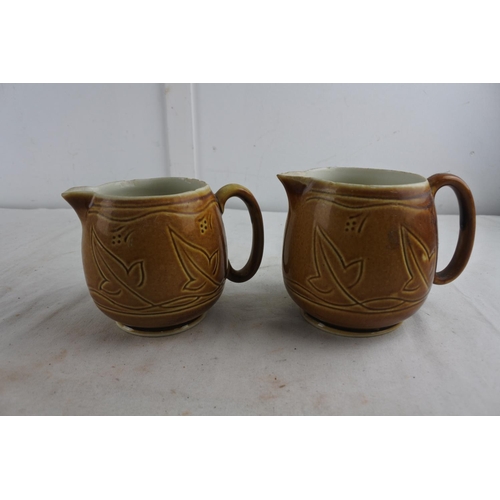 80 - A pair of decorative glazed pottery jugs.