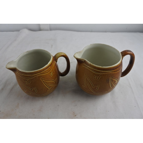 80 - A pair of decorative glazed pottery jugs.