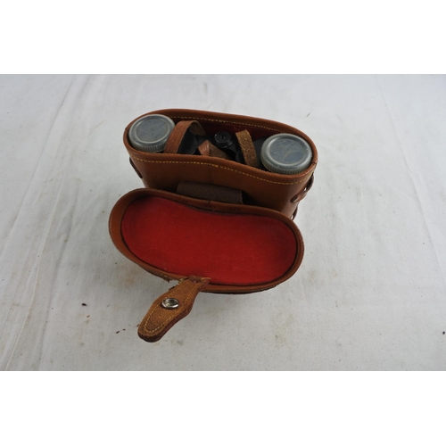 84 - A pair of vintage Orbit 8 X 30 binoculars and leather case.