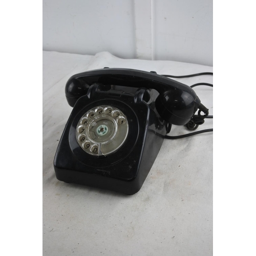 91 - A vintage black rotary telephone.