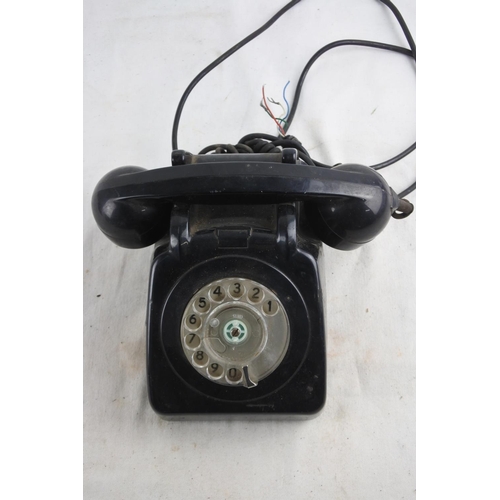 91 - A vintage black rotary telephone.