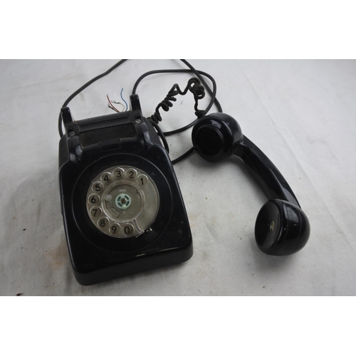 91 - A vintage black rotary telephone.