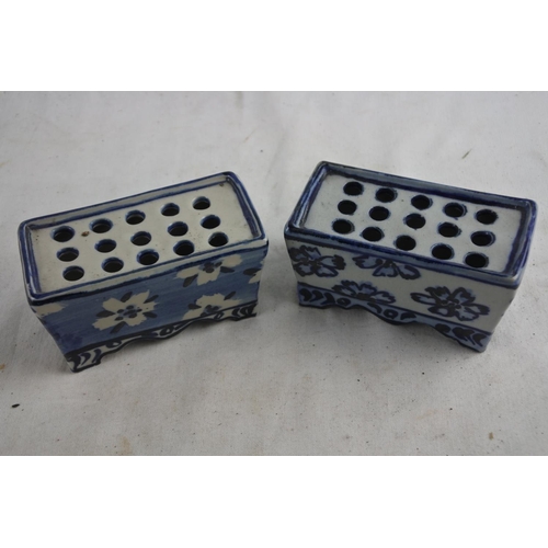 92 - A similar pair of ceramic blue and white flower holders.